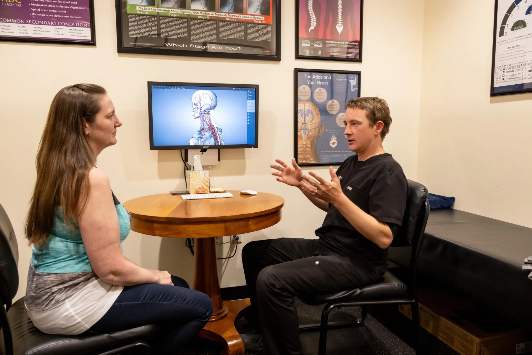 Dr. McCanse having a consultation with a patient to explore Upper Cervical Chiropractic as a care option at Precision Chiropractic in Vermont.