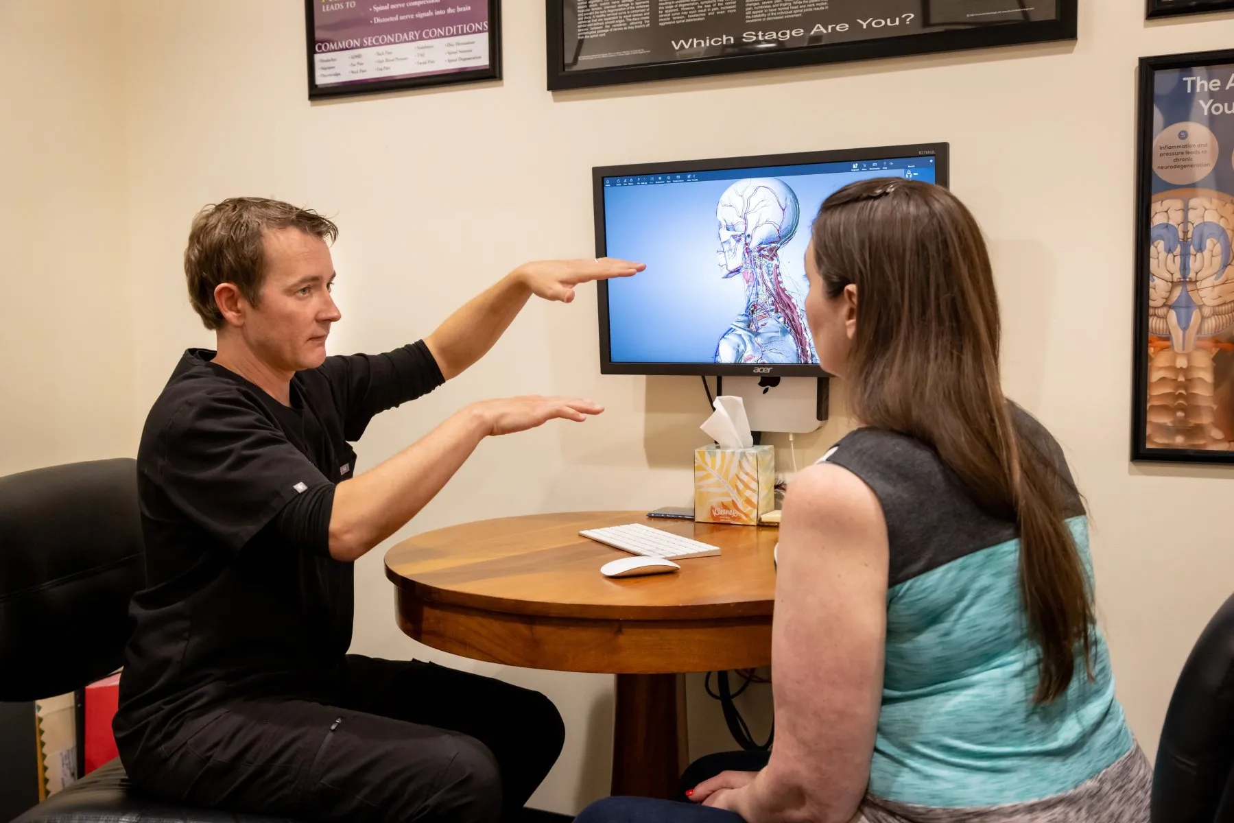 Doctor assessing posture and symmetry during a functional cervical evaluation at Precision Chiropractic in Vermont