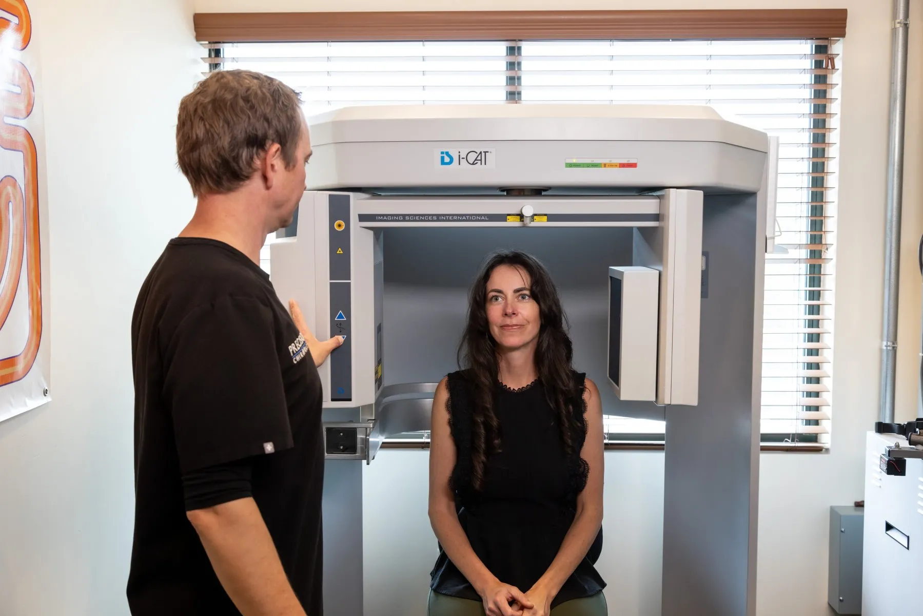 Patient undergoing Cone Beam CT scan in i-CAT machine for upper cervical chiropractic assessment at Precision Chiropractic in Vermont.